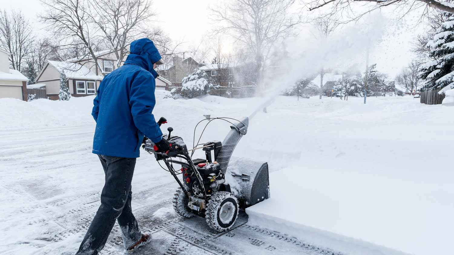Man clearing snow with a snow blower