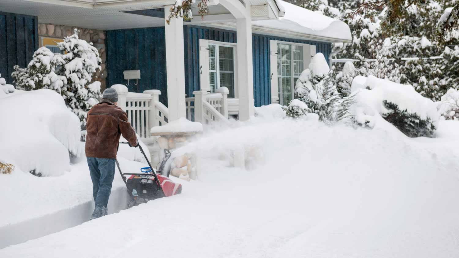 Man using snowblower in deep snow