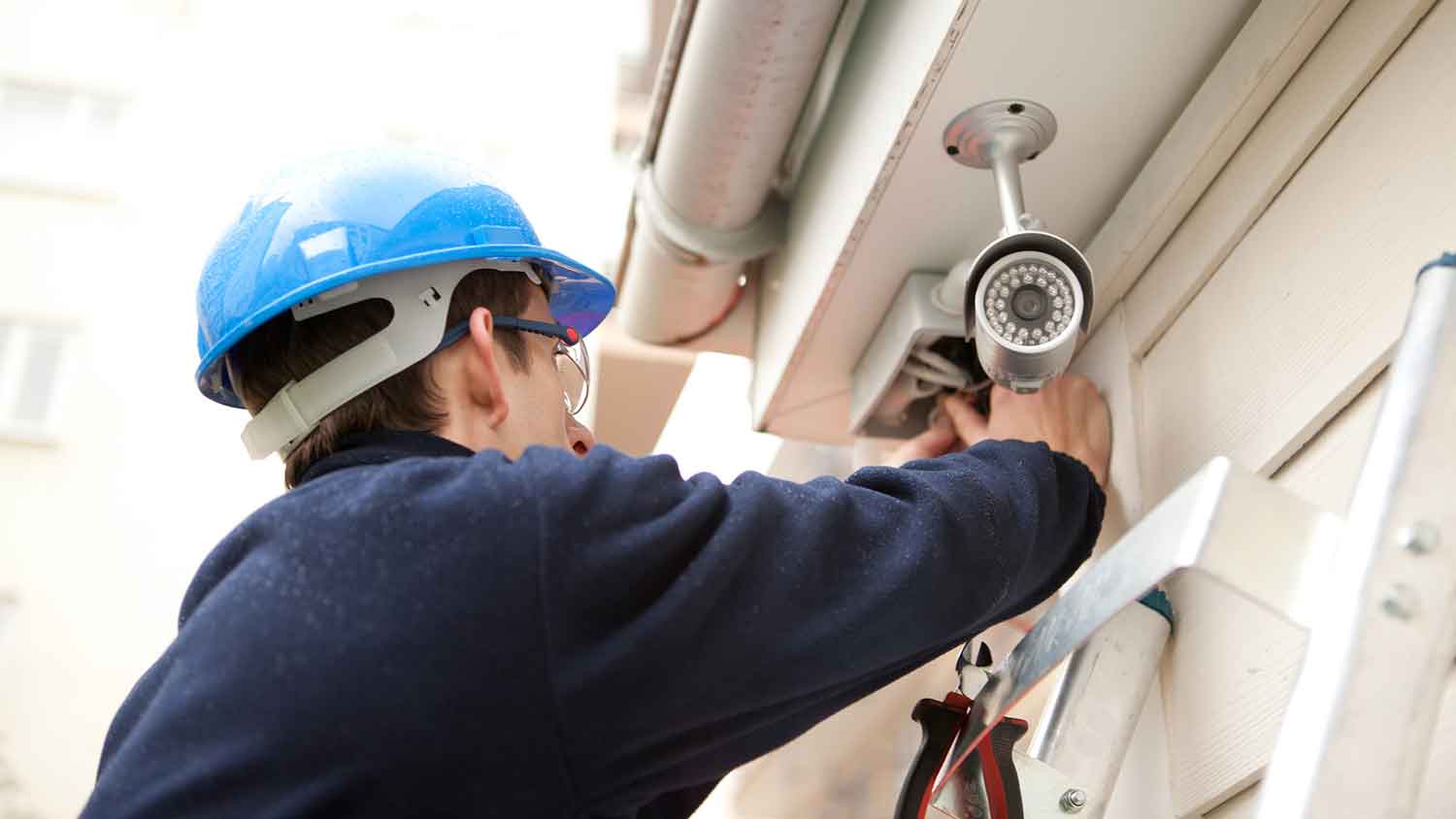 Technician installing hardwired security system