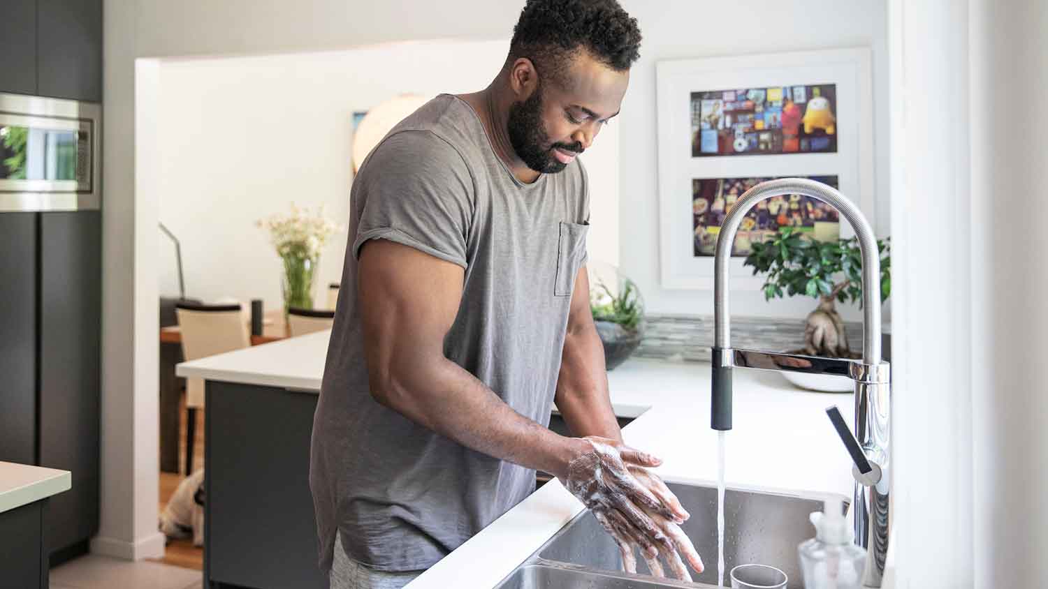 Man washing hands at the kitchen sink
