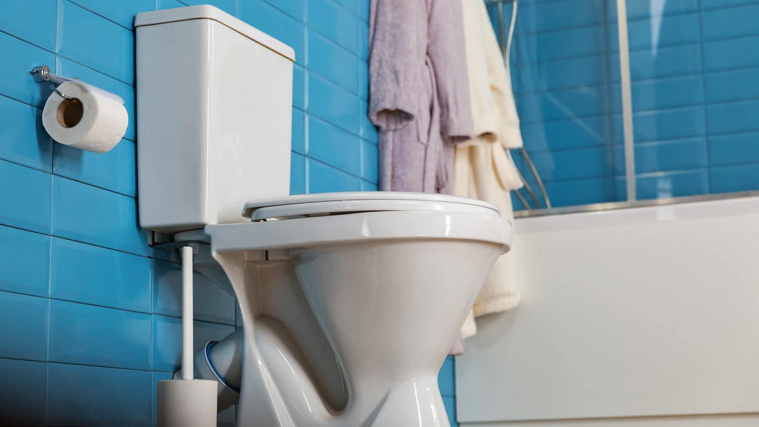 close up of a toilet bowl in a blue bathroom