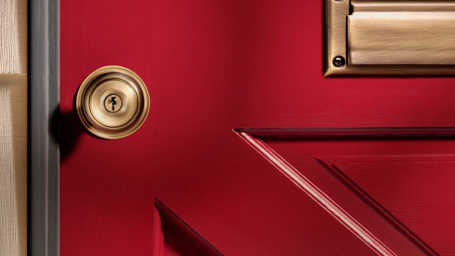 Close-up of a door knob on a red door