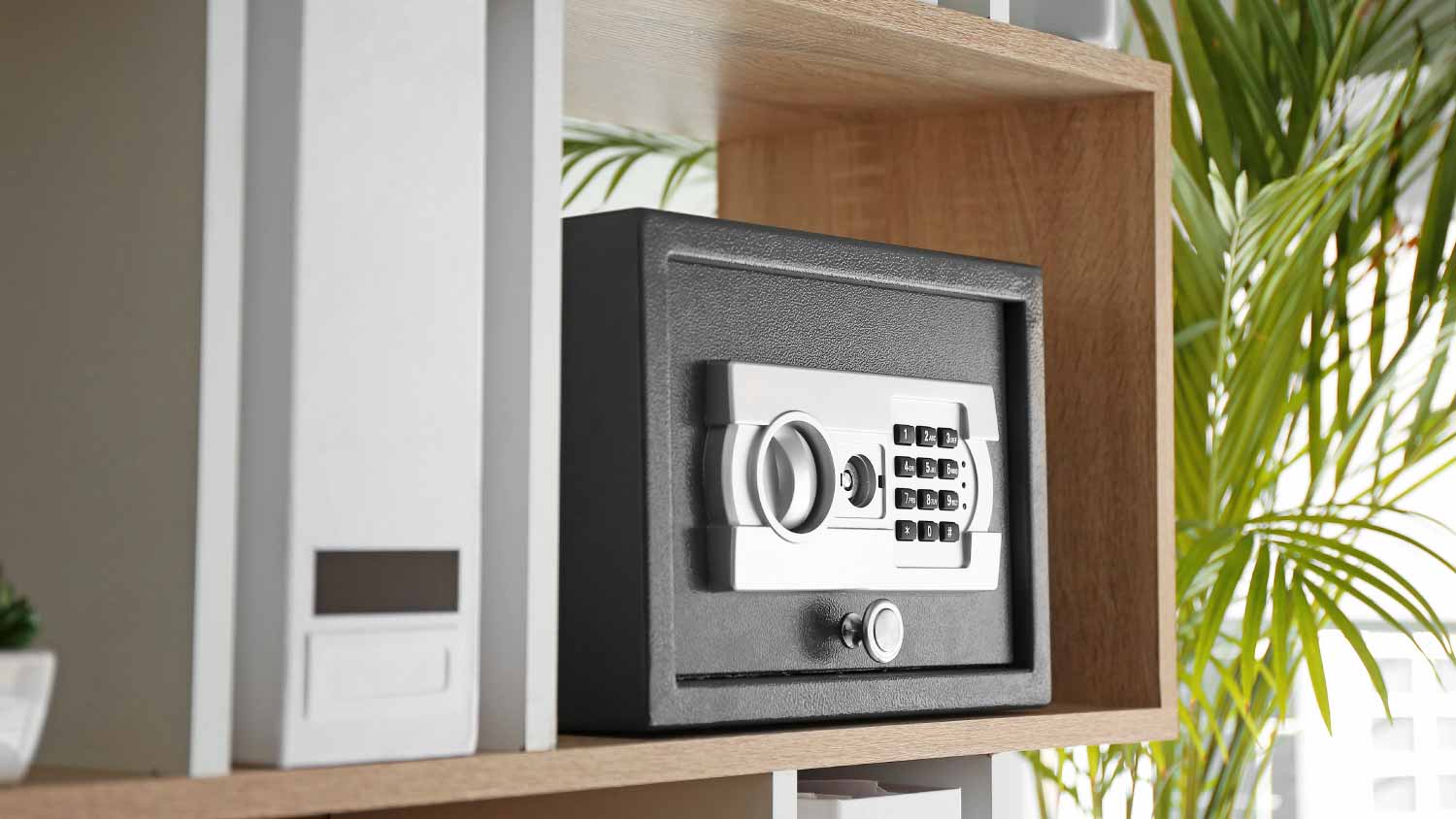 Modern safe on shelf in office