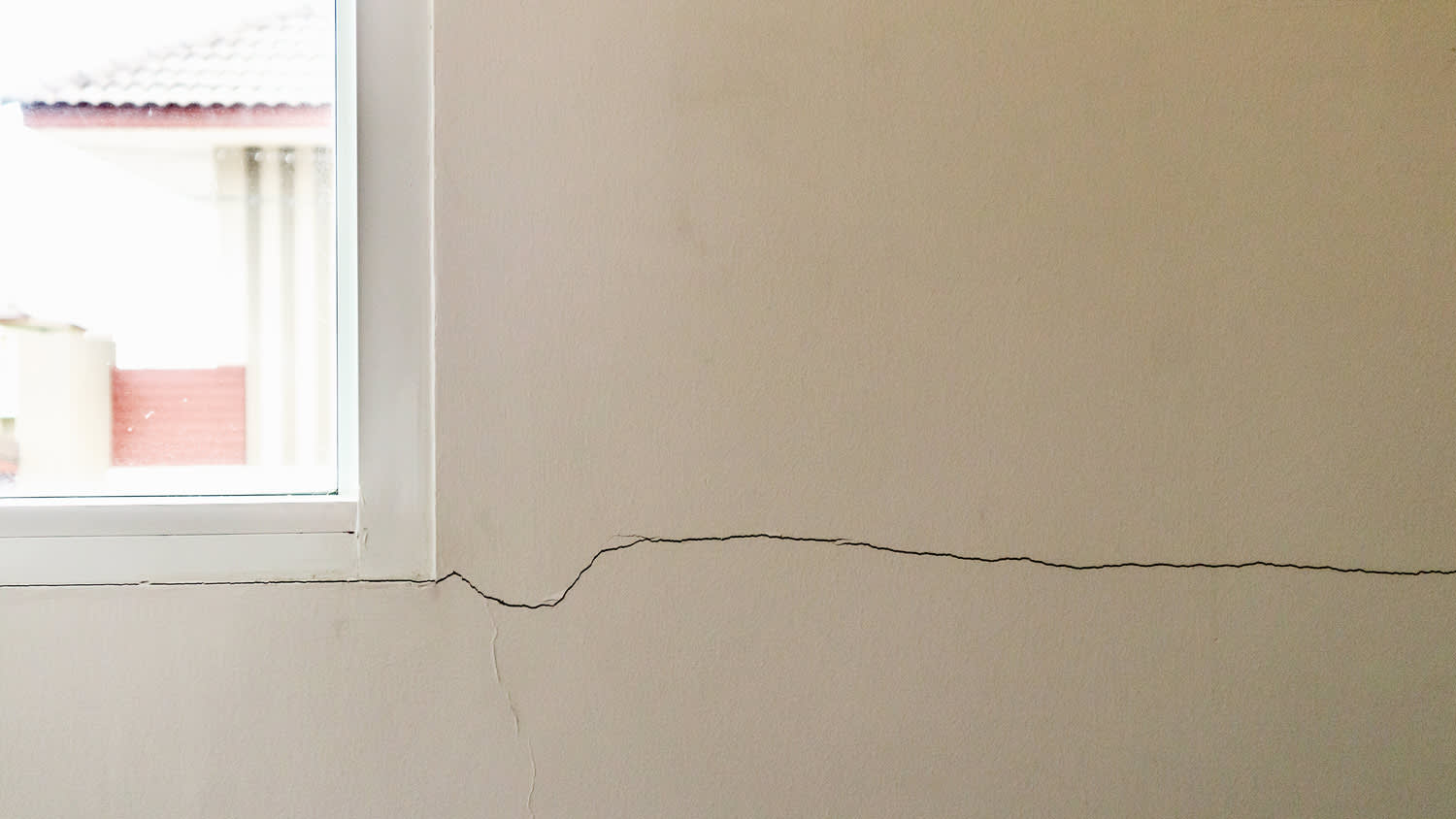 New house wall crack near window frame