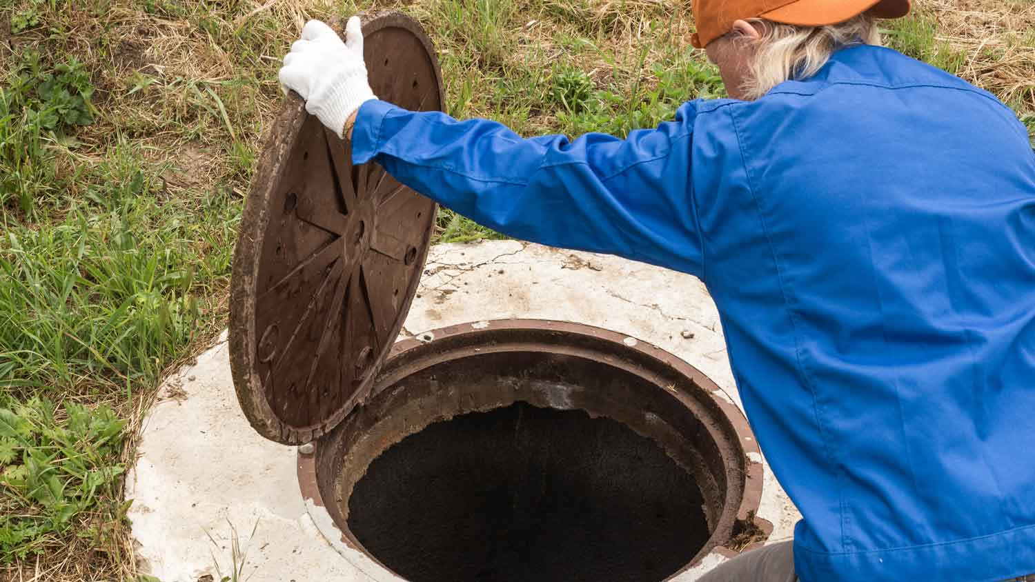 A woman inspecting a septic tank