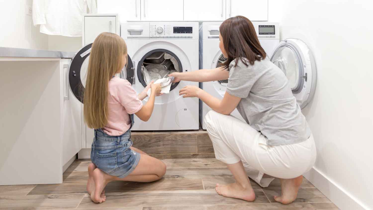 Daughter helping mom in the laundry room
