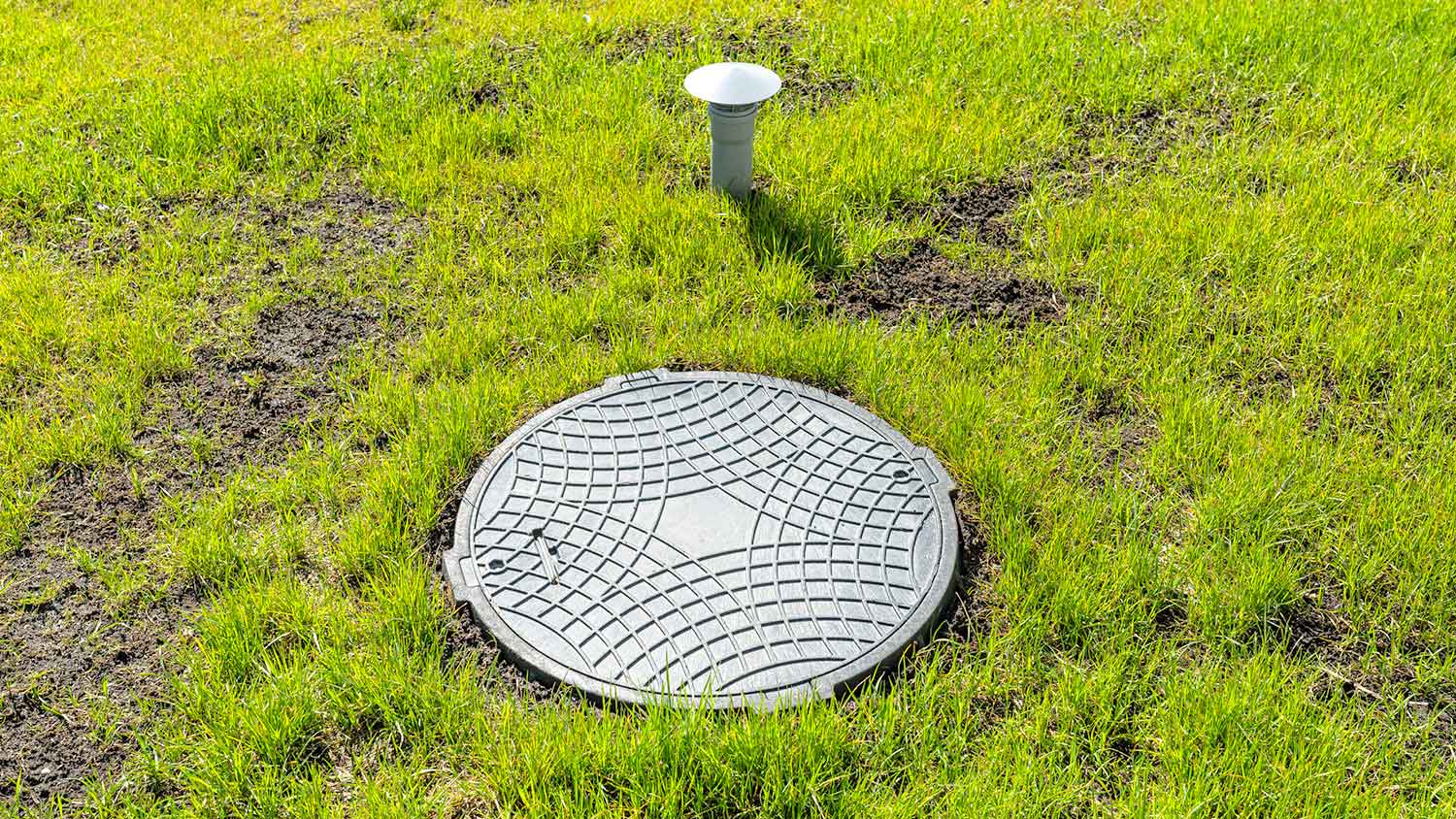 Home septic tank and vent in the yard