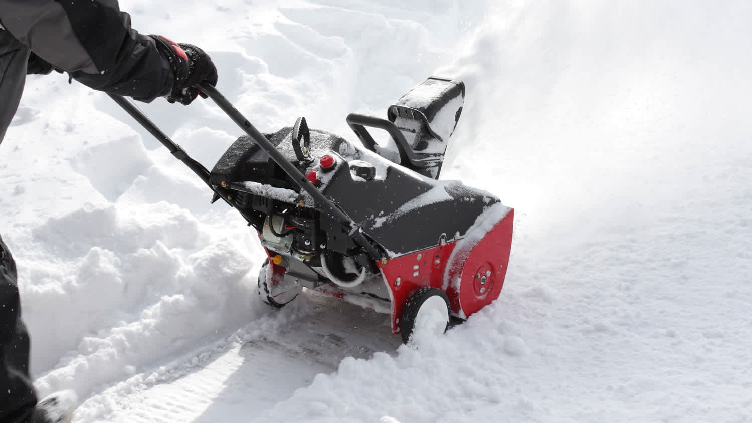 Man removing snow after storm with a snowblower