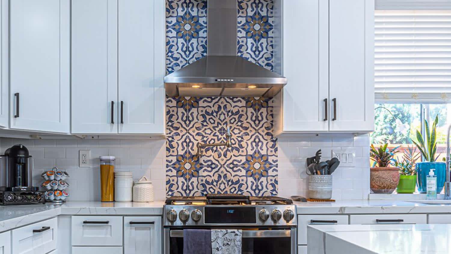 Kitchen with white cabinets and range hood
