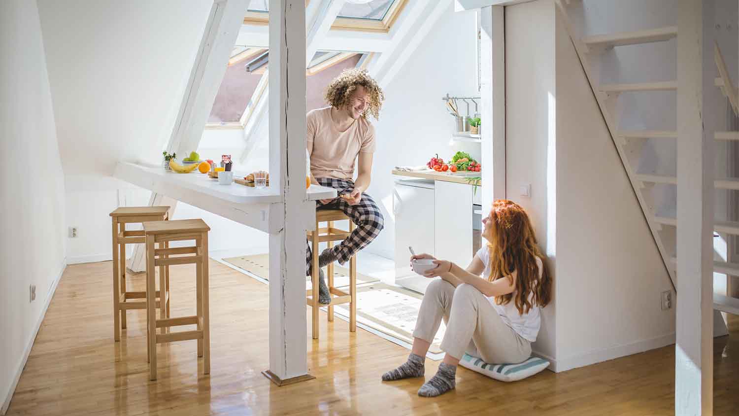 Couple in an attic apartment having breakfast