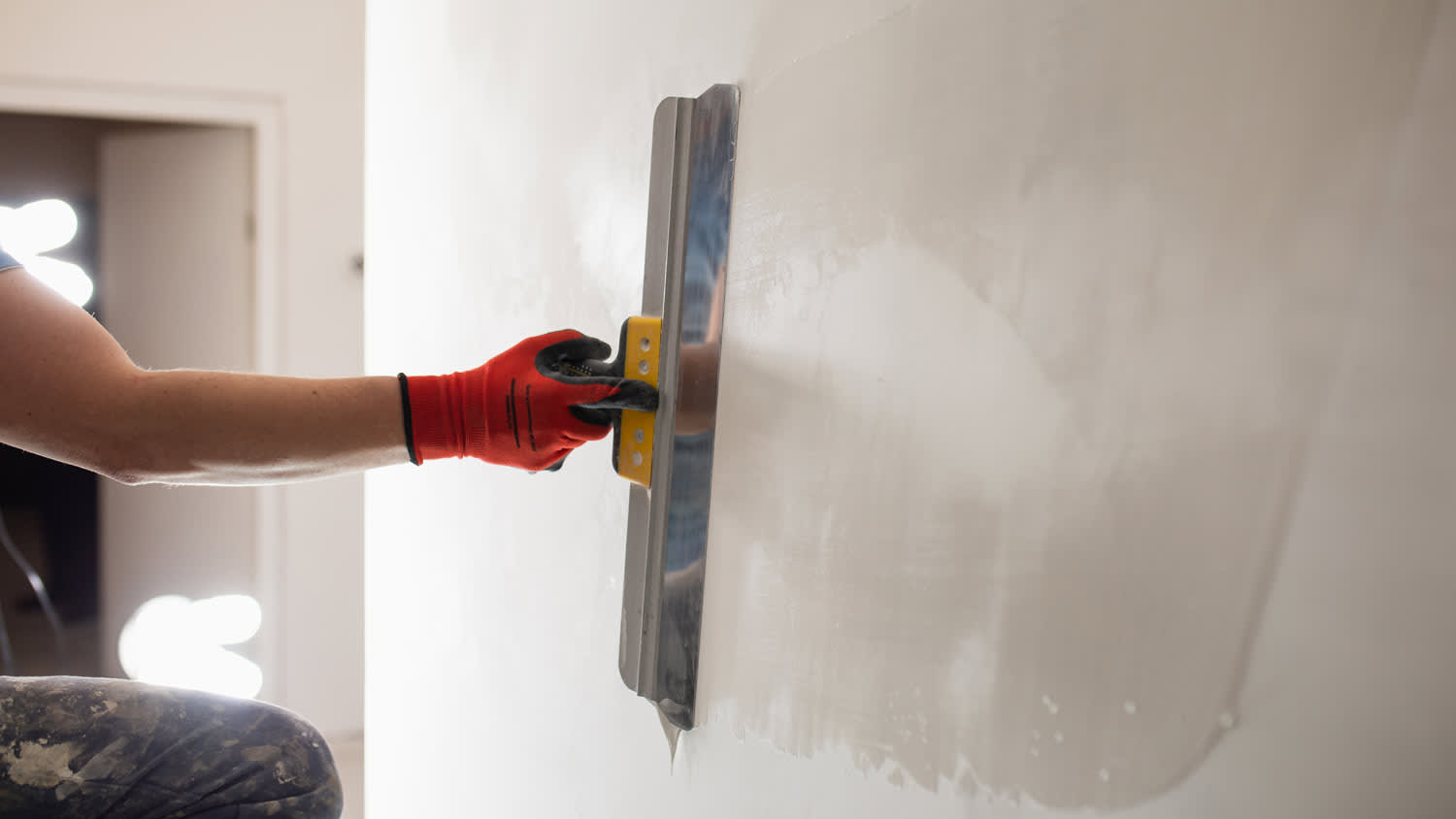 person applying drywall to drywall