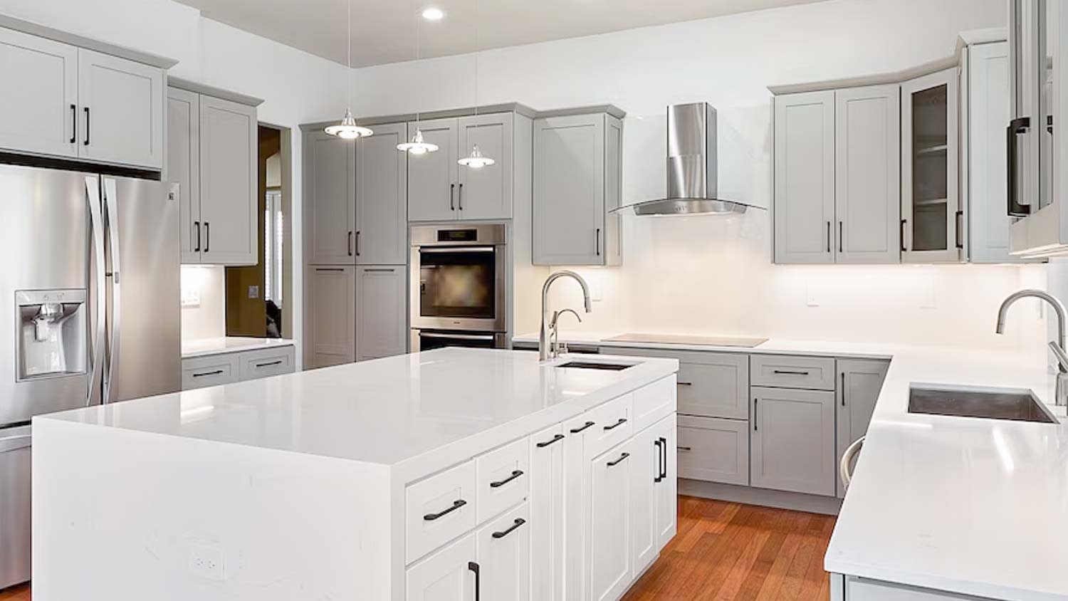 Kitchen with gray cabinets and range hood