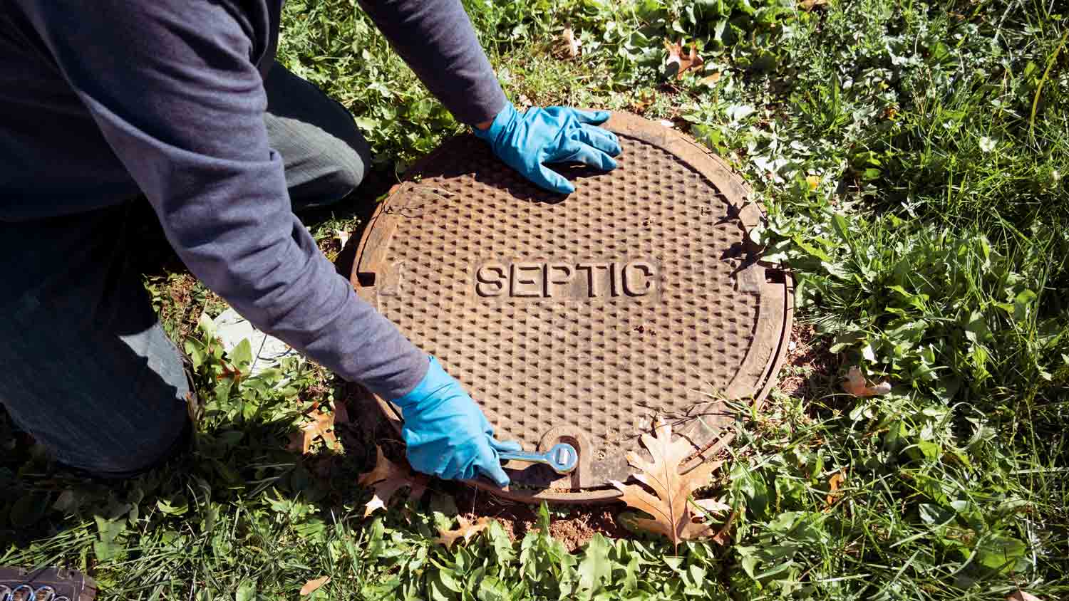 plumber opening septic tank