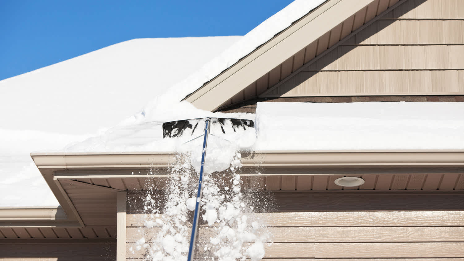 Roof Rake Removing Winter Snow