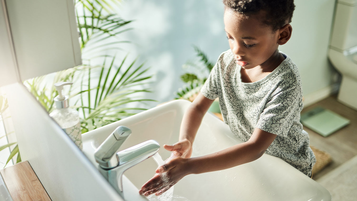 Boy in the bathroom washing hands