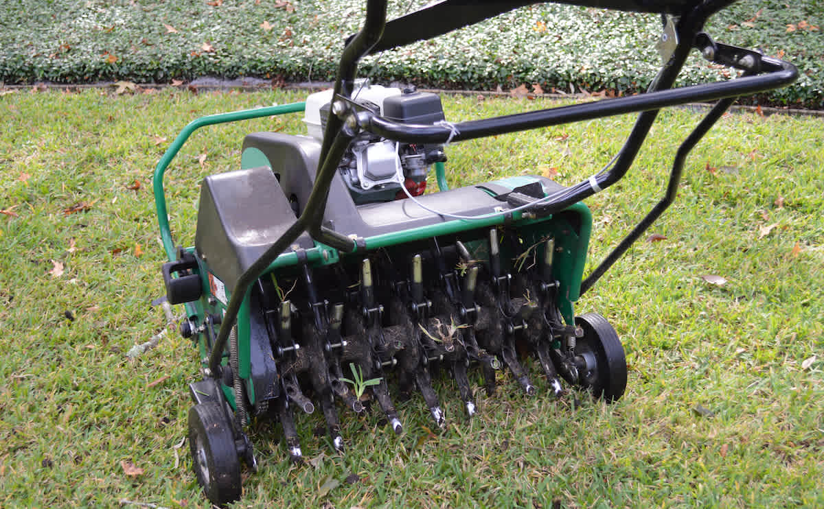 Lawn aeration machine with grass plug