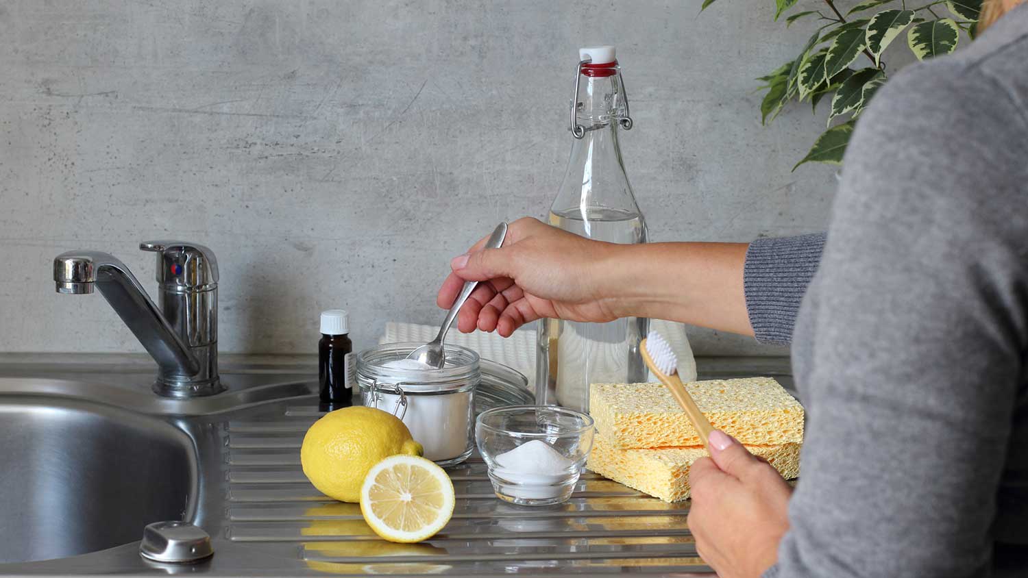 Woman making natural house cleaner with baking soda