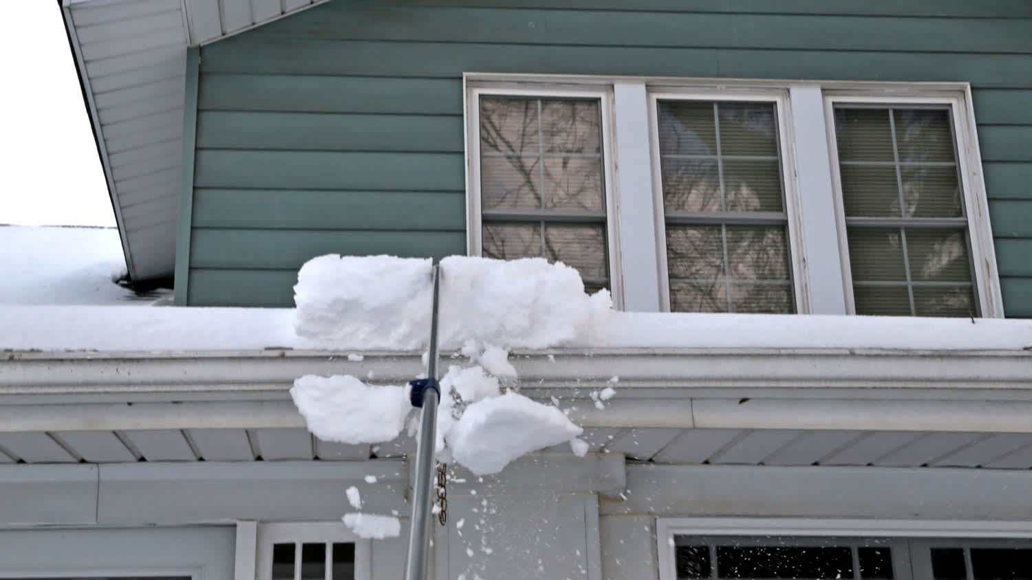 Snow Roof Rake clears the snow off of the building roof