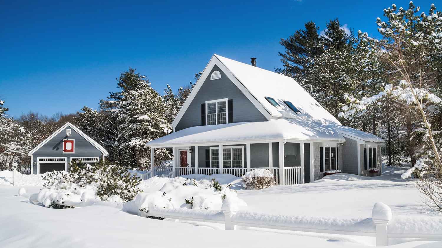 House with large front porch covered with snow
