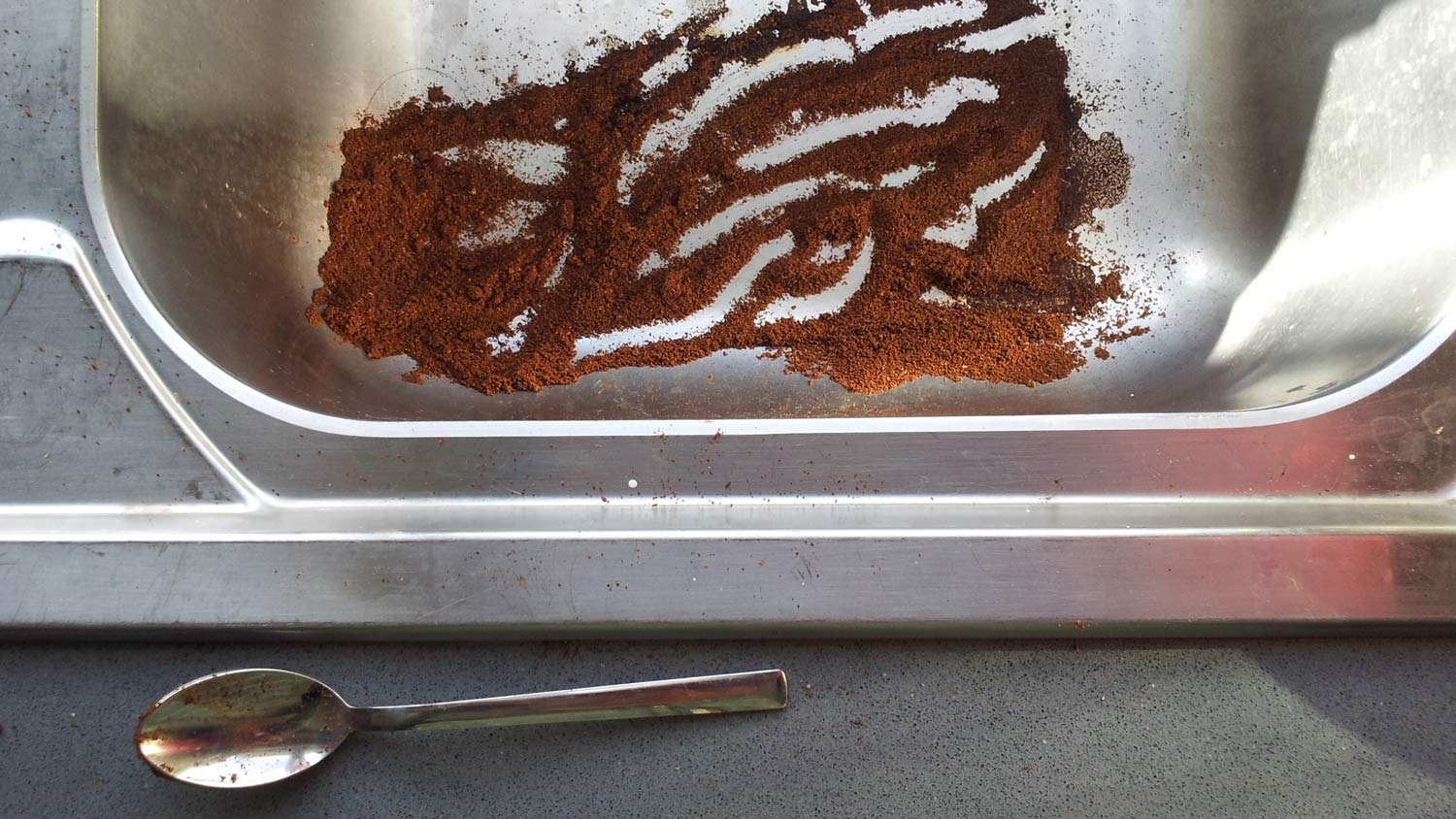 Coffee spilled in a kitchen sink