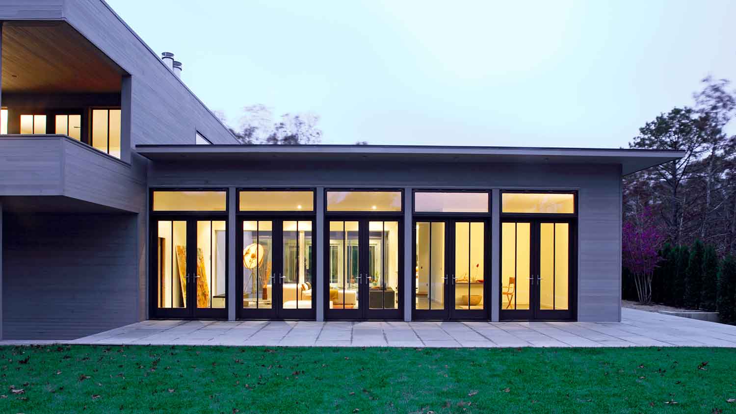 Modern house with lights on at dusk