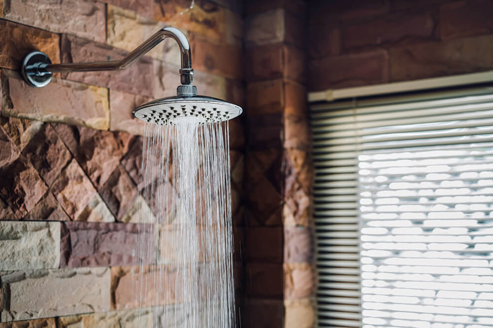 Modern brick style shower running hot water