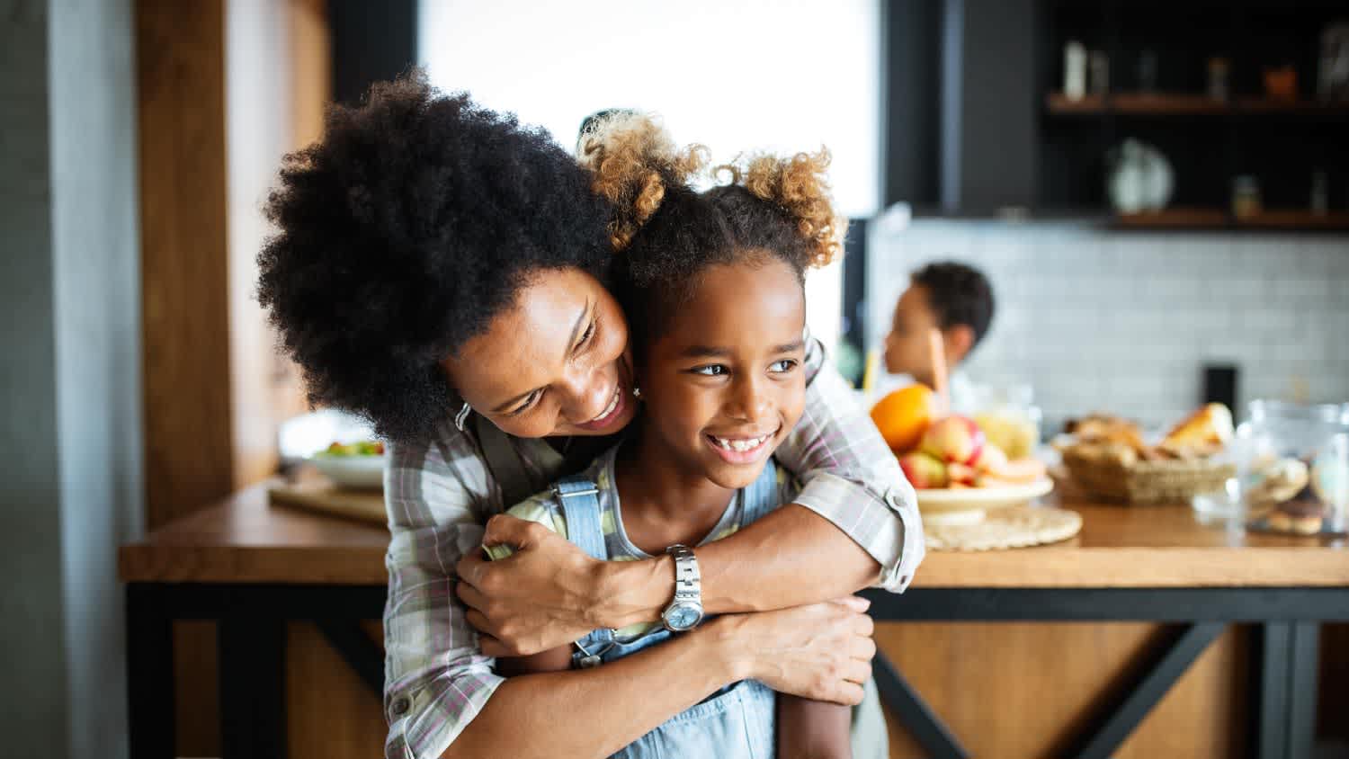 Happy mother and children in the kitchen