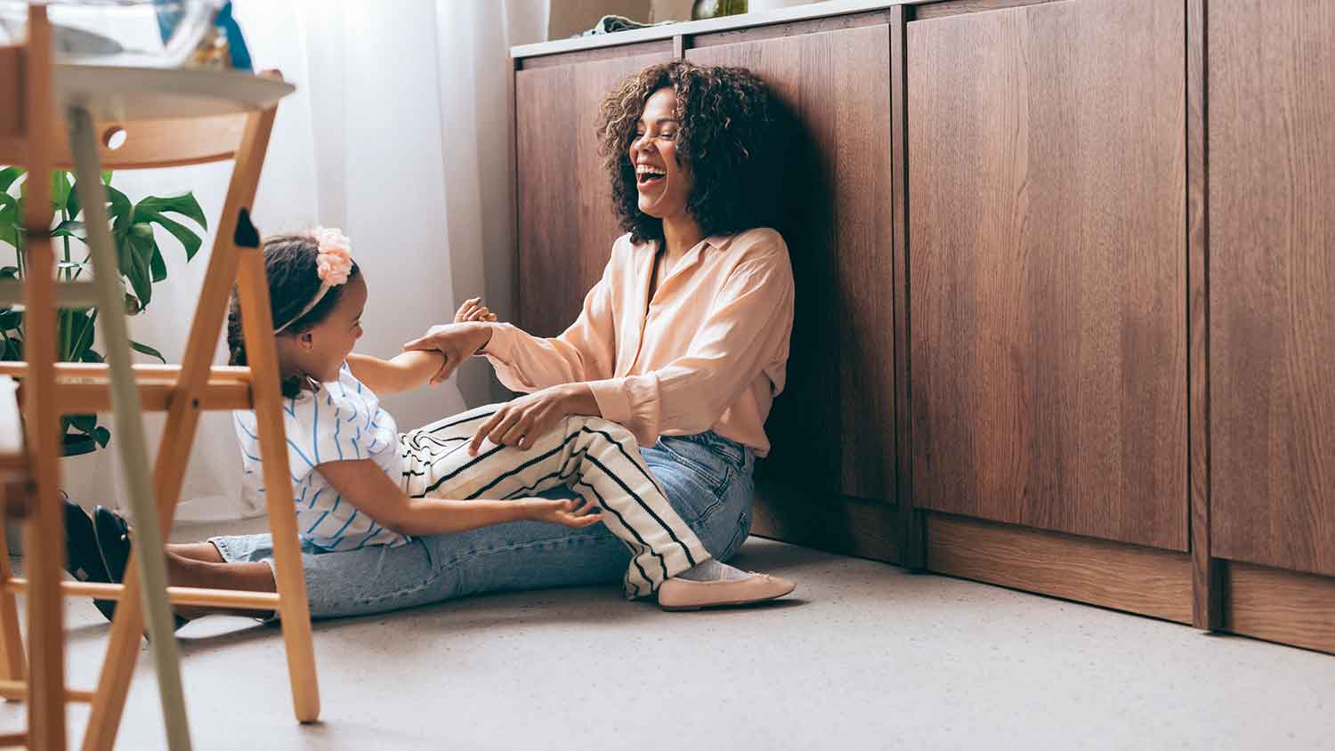 Mom and daughter sitting on the floor and playing