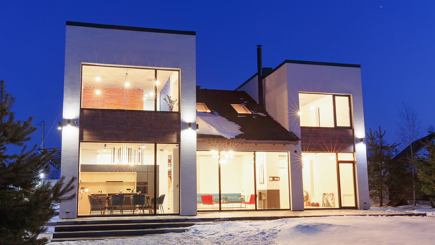 House lit up on snowy night