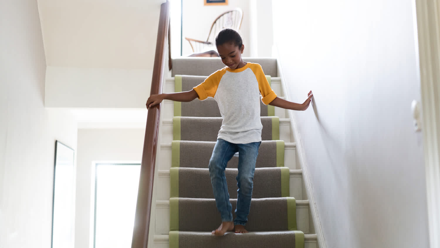 Full length of girl on staircase at home