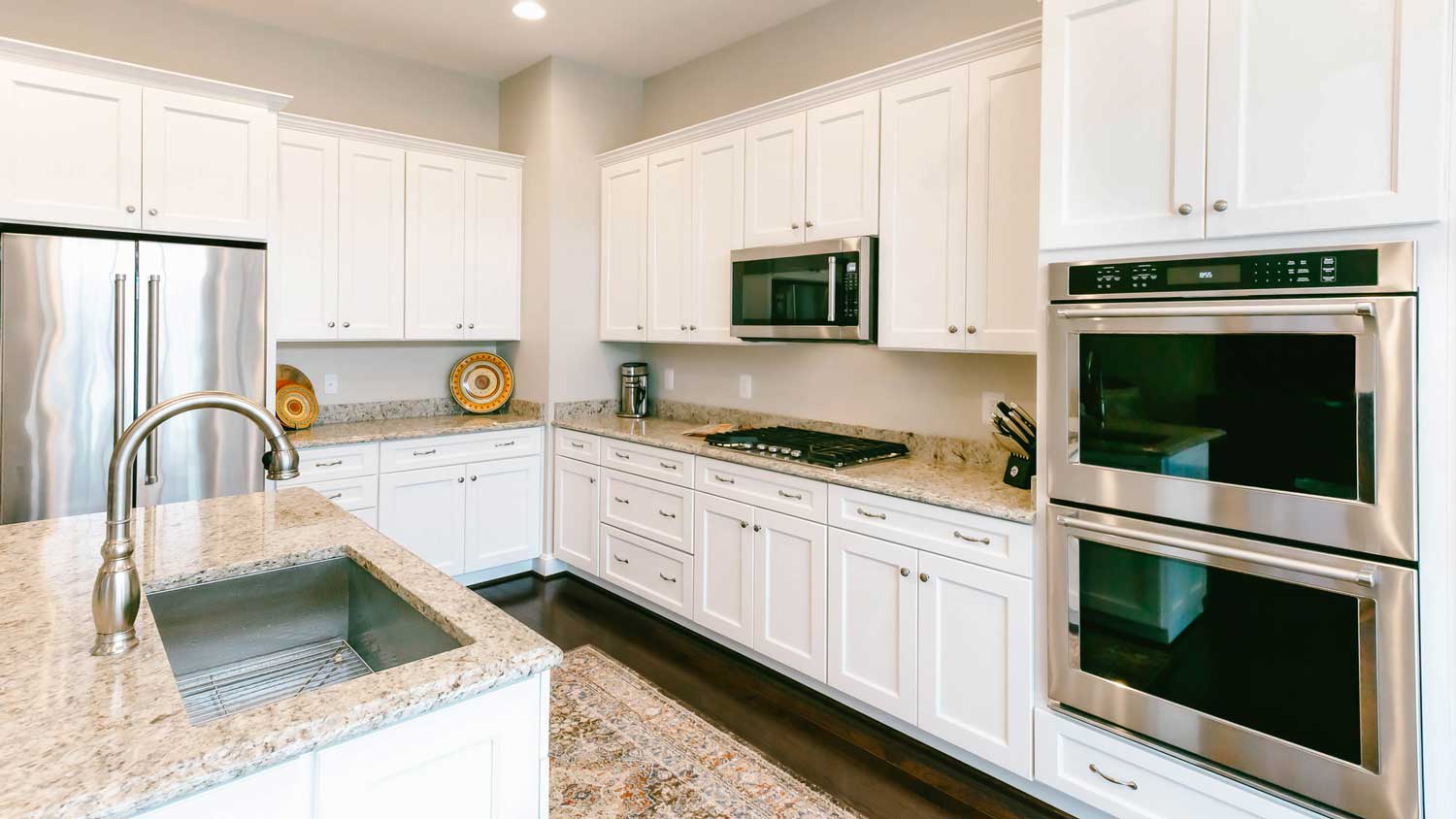 A kitchen with a wall oven and a microwave oven