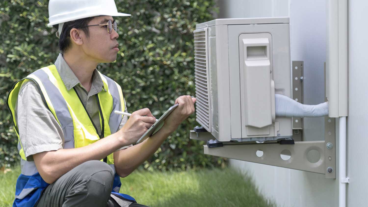 A person estimating the wattage of a heat pump