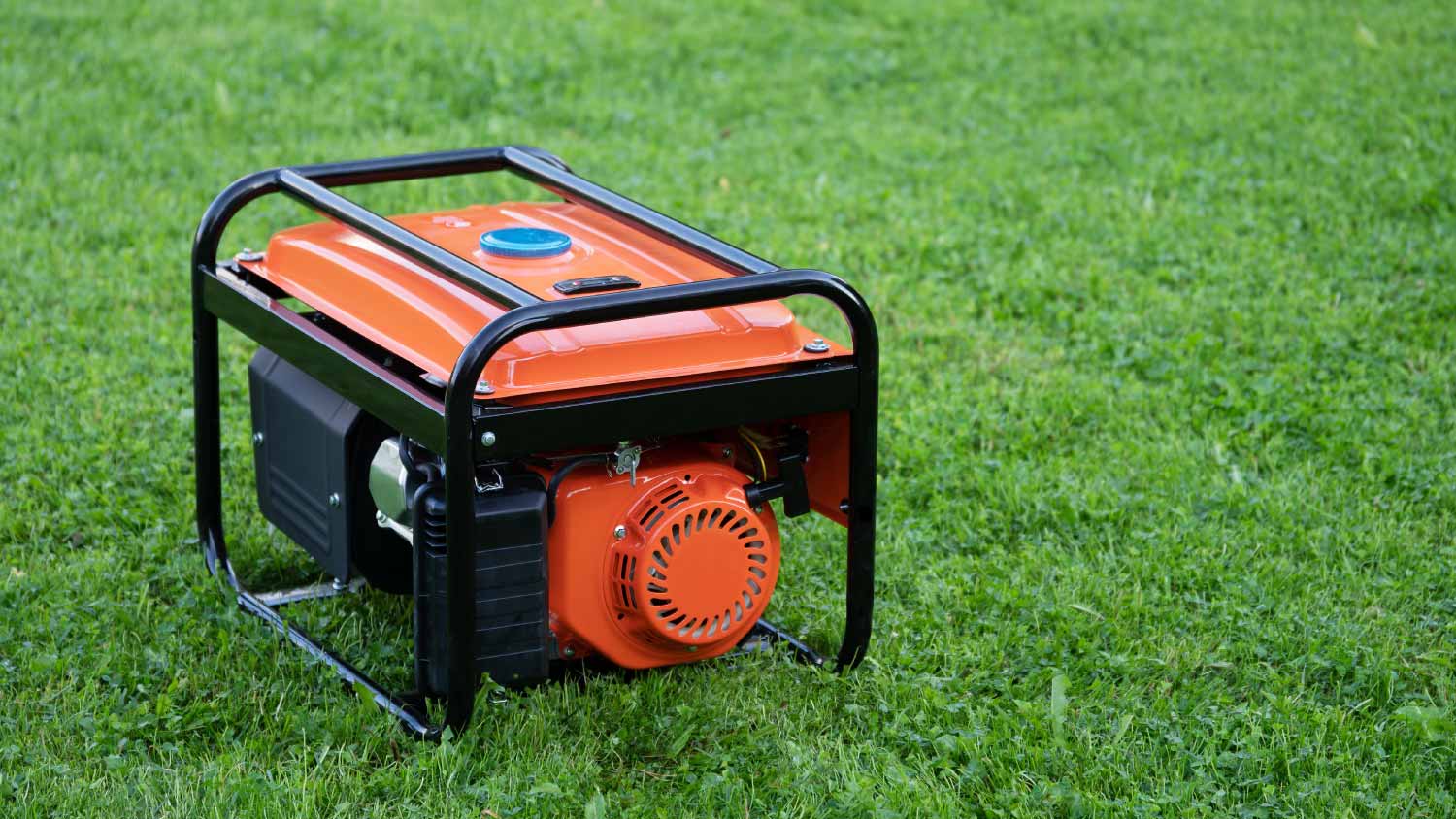 Portable electric generator on the green grass