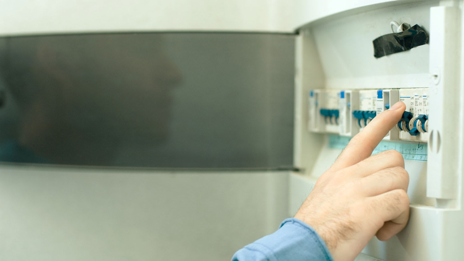 A man switching a fuse