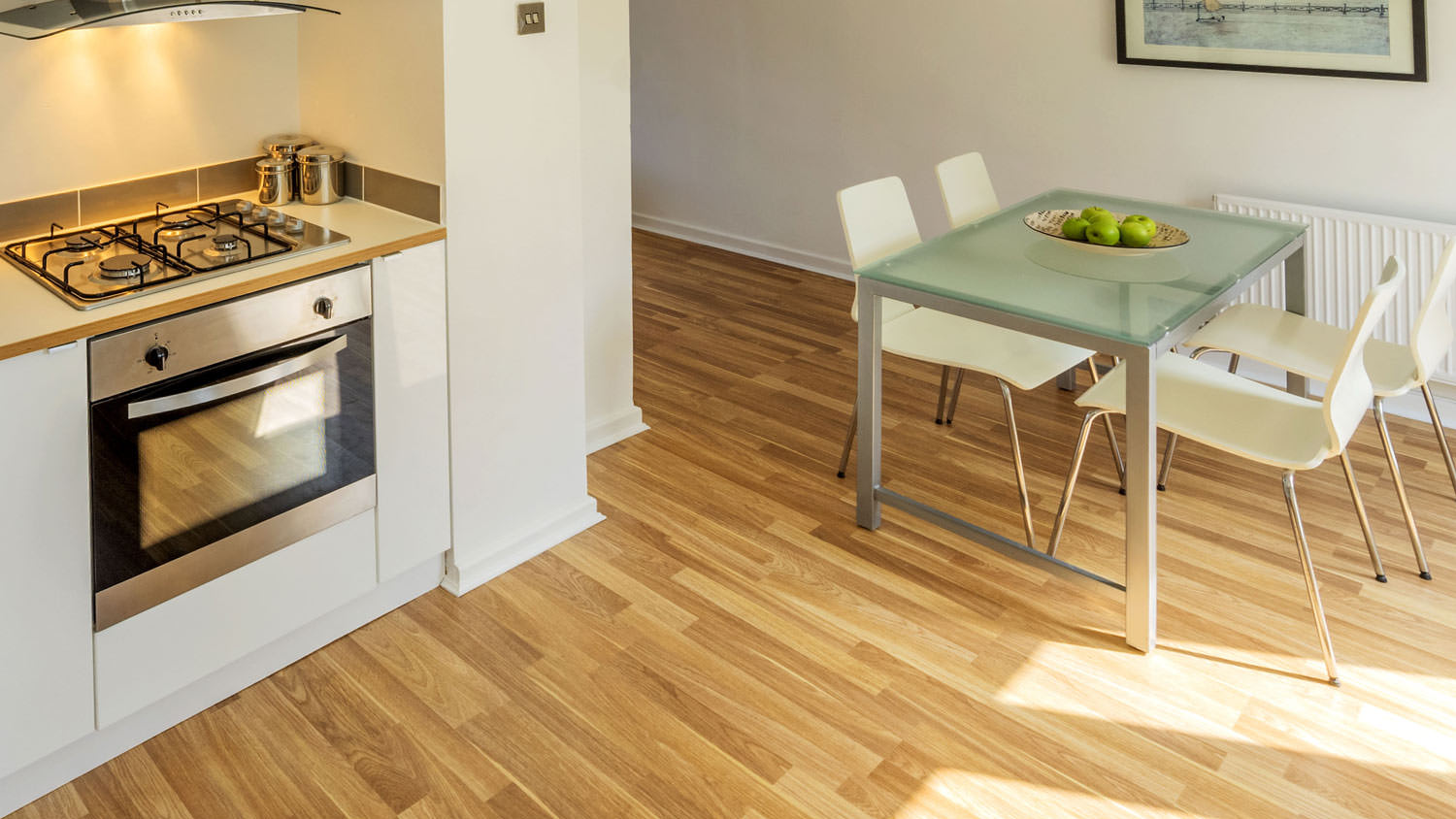 An open-plan kitchen with laminate floor