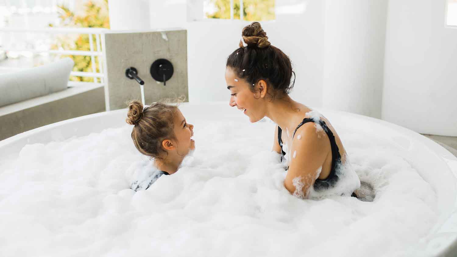 Mother and daughter having fun in the jacuzzi