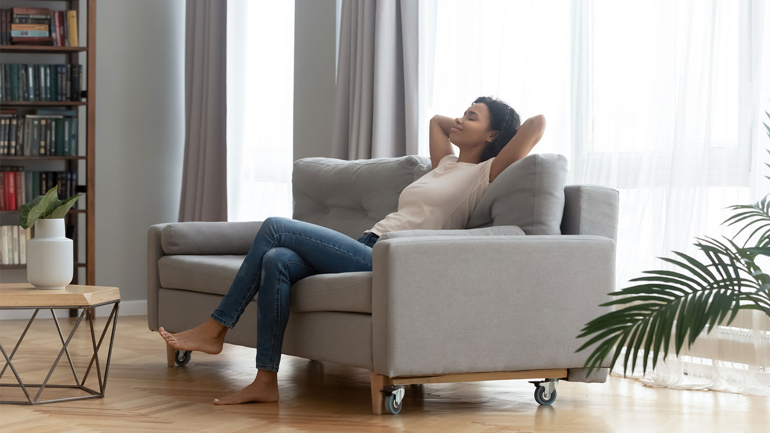 Woman breathing air and relaxing in her living room