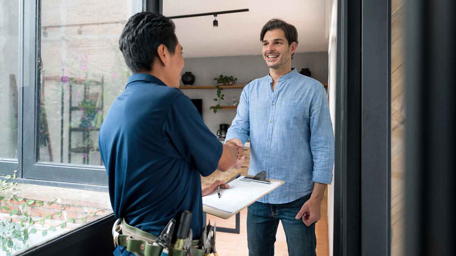 Happy client shaking hands with contractor