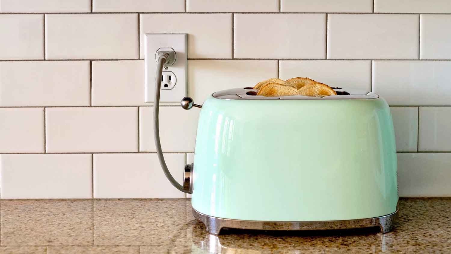 Toaster on a countertop plugged into a wall outlet