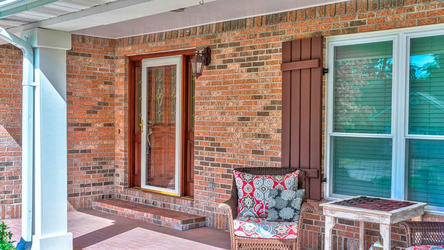 Front porch of a house with a storm door