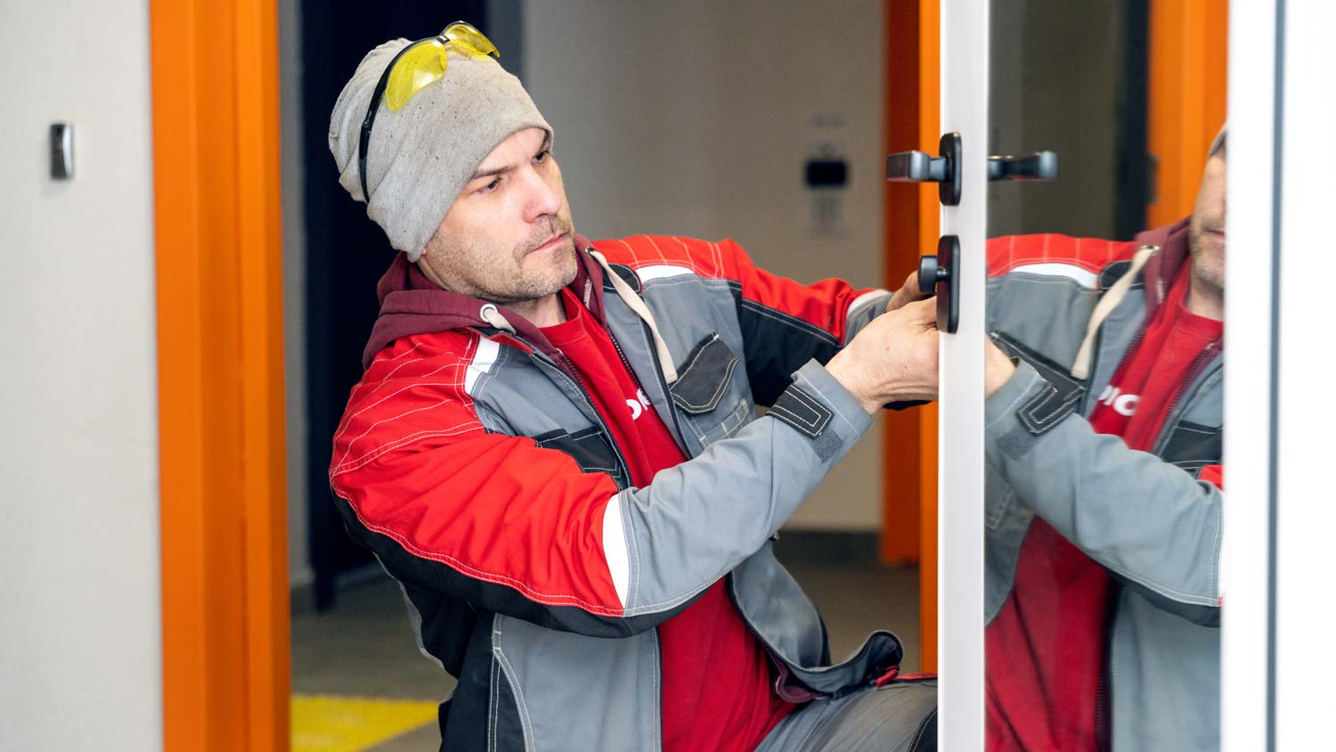 A man fixing a storm door