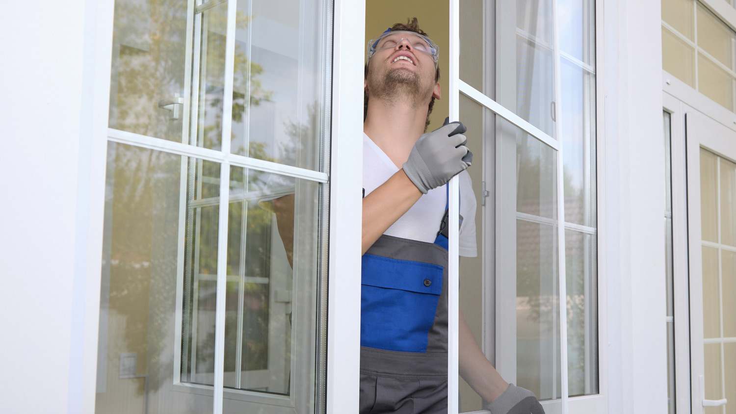 Man installs storm window