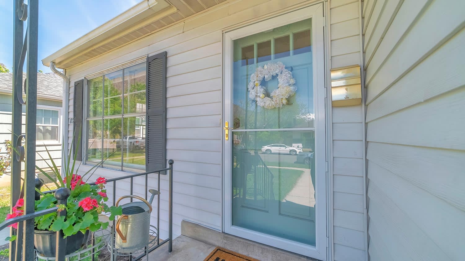 House with glass storm door covering green front door