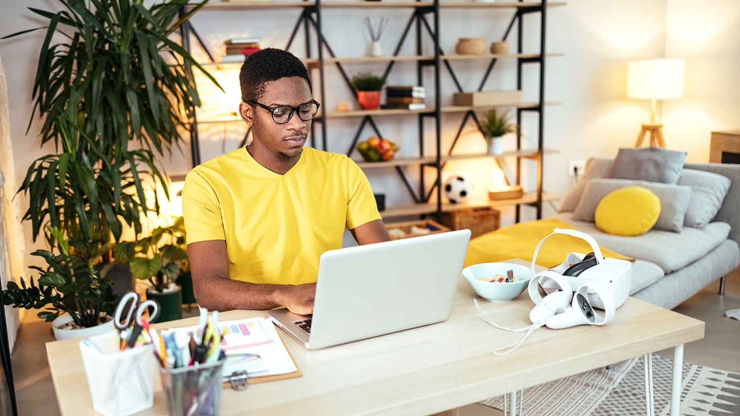 Young man using laptop to do his homework