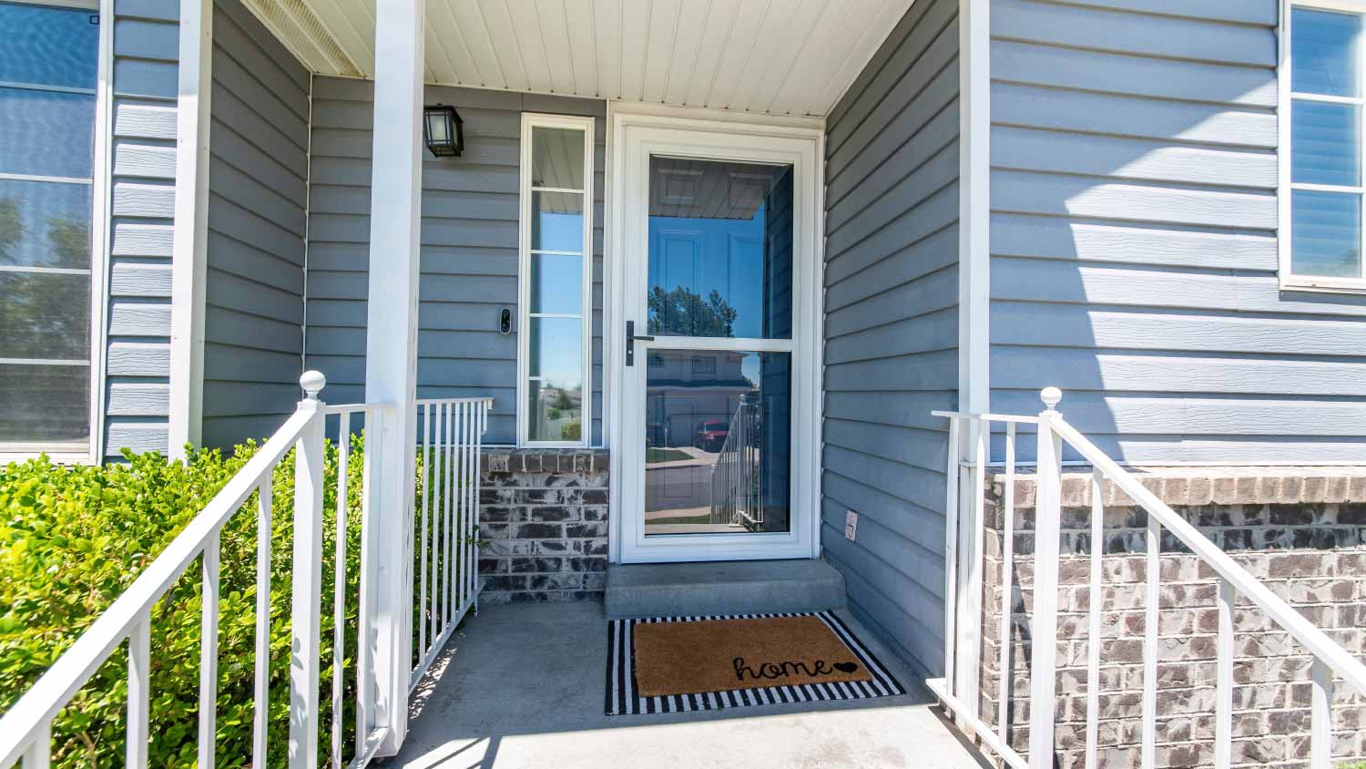 Front porch of a house with glass storm door
