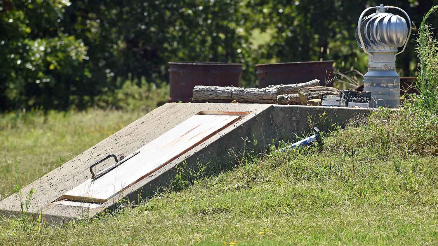 Below-ground storm shelter reinforced with concrete