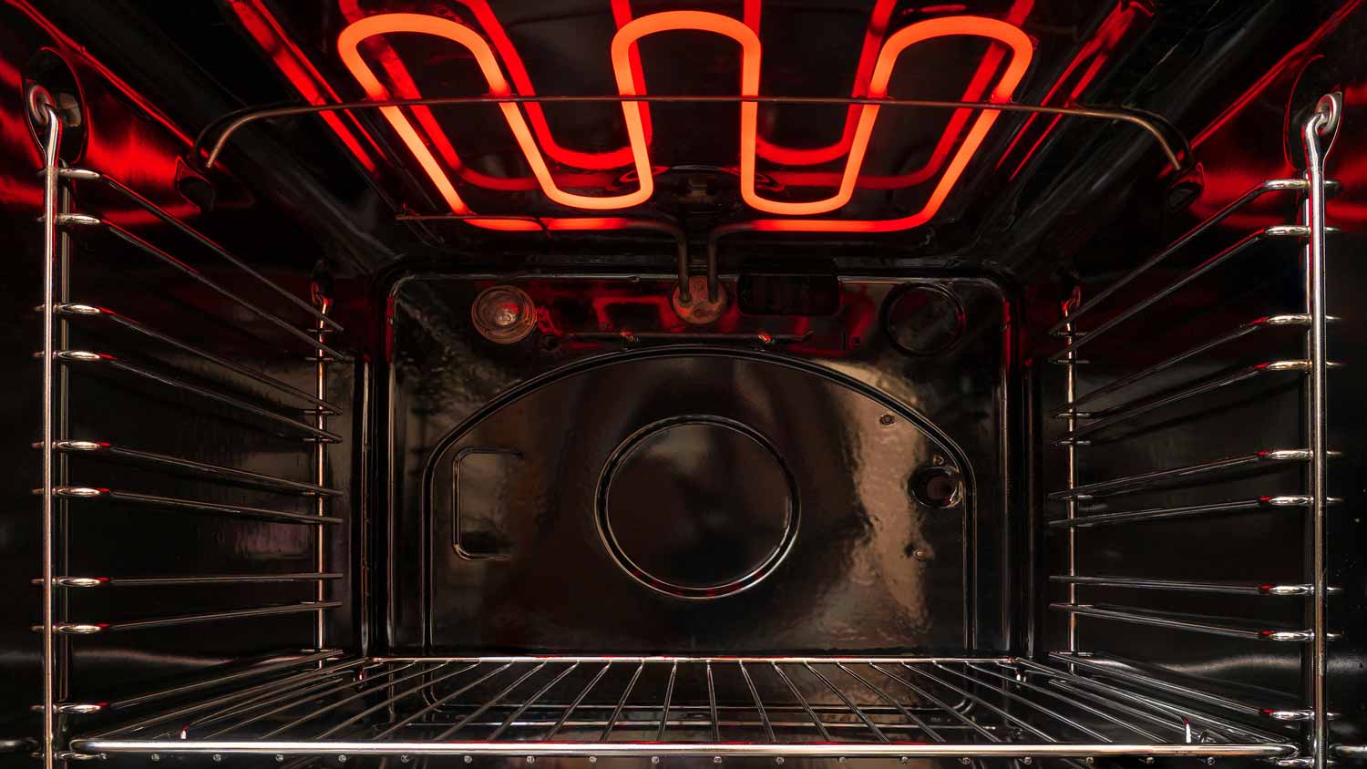 The interior of an oven with the coils burning