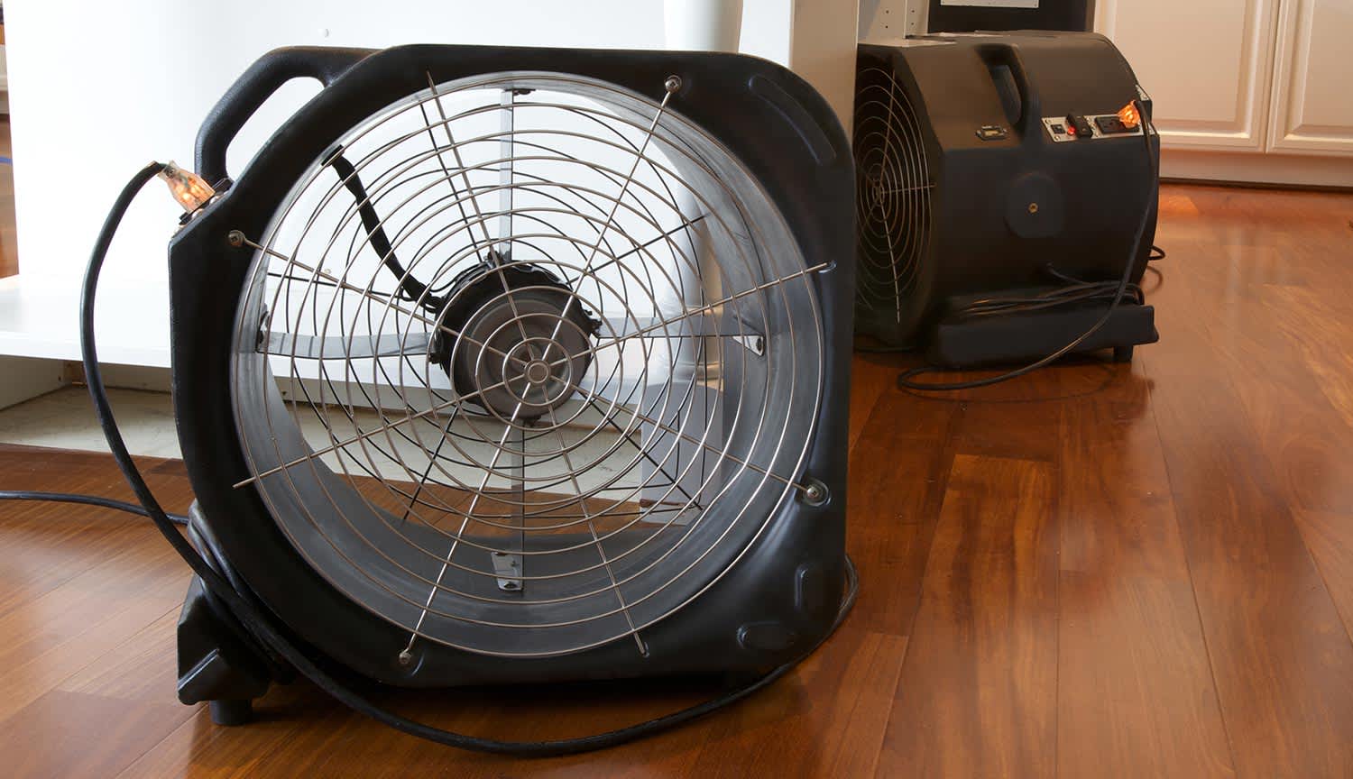 Electric fan turned on drying hardwood floors