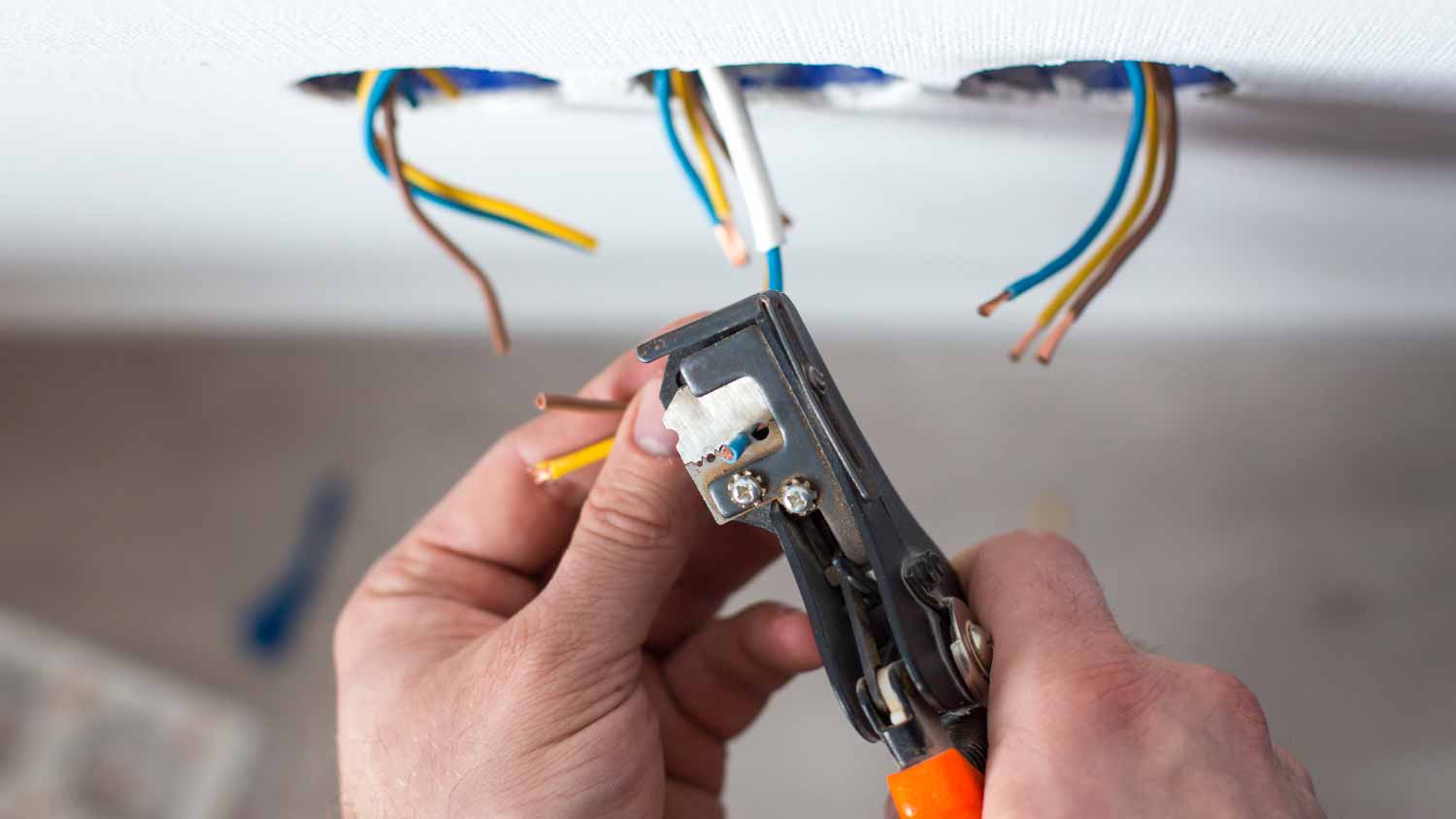 Electrician stripping insulation from wire