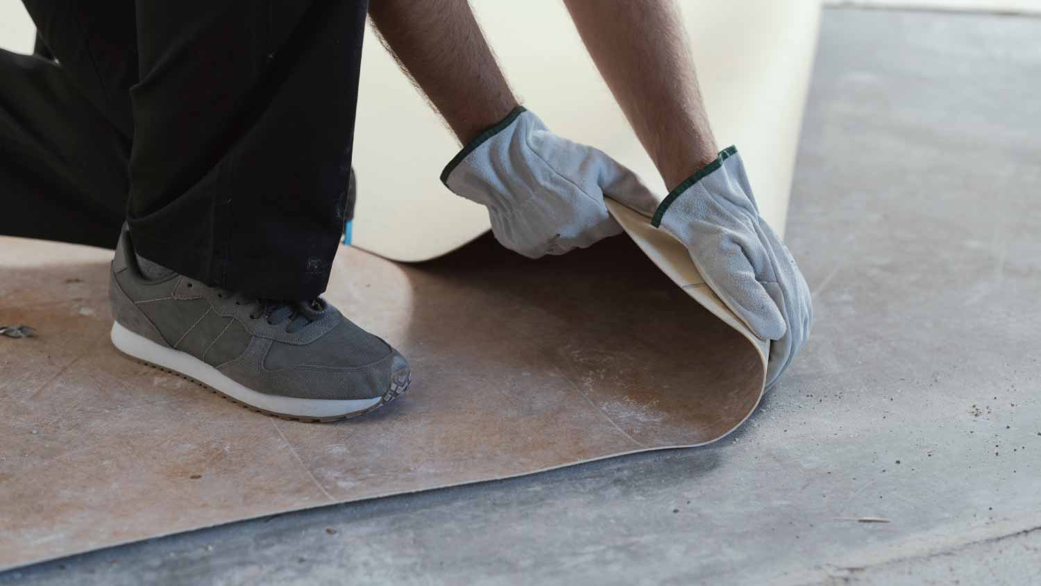 Man removing an old linoleum flooring